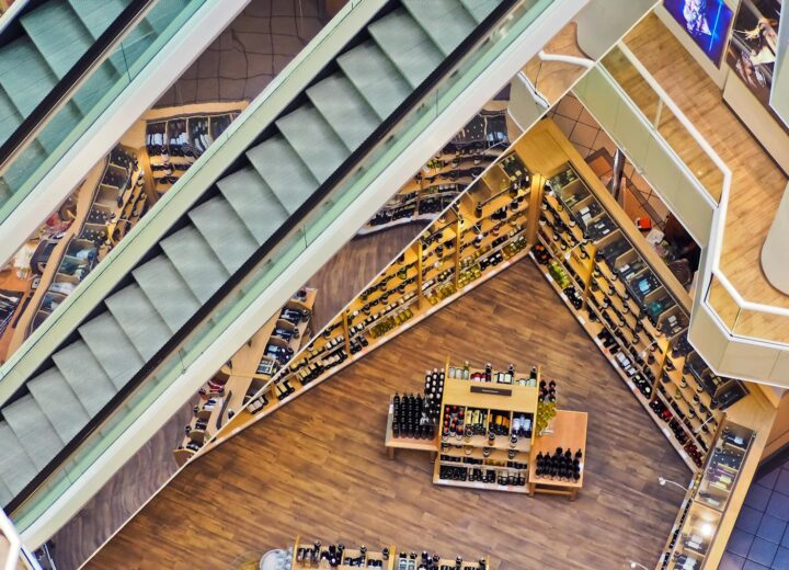 Aerial view of a stylish shopping mall showcasing escalators and well-organized retail displays.